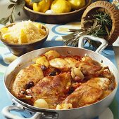 Braised rabbit with olives and a bowl of couscous