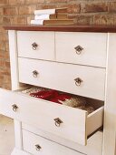 White chest of drawers with one drawer open