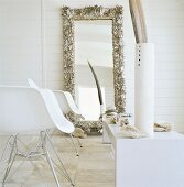 Two designer chairs and mirror on wall