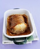 Rolled roast pork in a roasting dish