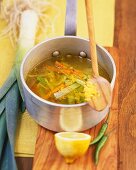 Leek and carrot soup with ginger and garlic in pan