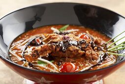 Asian hot and sour soup with shrimps and chocolate sauce