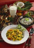 Vegetables in coconut sauce, lassi and raita (India)