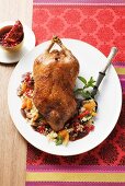 Roast duck with fruits and chilli on a bed of couscous