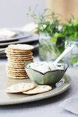 A herb dip with crackers