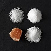 Four different types of salt on stone background
