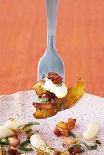 Fried potatoes with bacon and white beans