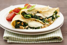 Pancakes filled with spinach, mozzarella and pine nuts