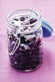 Sugared bilberries in a preserving jar (Vaccinium myrtillus)