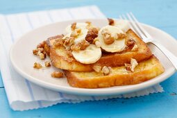 French toast with banana, maple syrup and walnuts