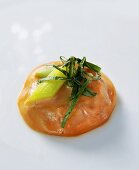 Salmon ravioli with spring onion and basil