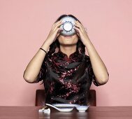 Asian woman, eating from bowl