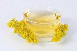 Lady's bedstraw tea in glass cup and saucer