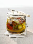 Pickled vegetables in preserving jar with fork