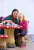 Mother with small daughter at laid table