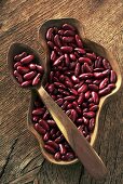 Red beans in wooden dish and on wooden spoon