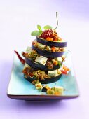 Aubergine tower with tofu, peppers, tomatoes, chilli, oregano