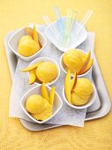 Several portions of mango ice cream on tray