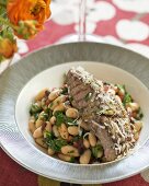 Grilled lamb steak with warm bean salad