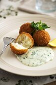 Fish and potato balls with parsley sauce