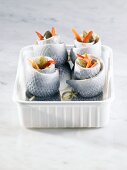 Several rollmops in plastic container