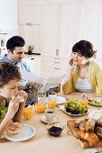 Young family with son having breakfast