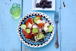 Greek salad, olives and olive oil (overhead view)