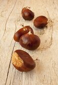 Several chestnuts on wooden background