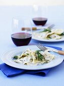Ravioli with pancetta and rosemary, glasses of red wine
