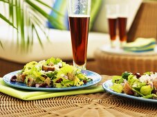 Romaine lettuce with cherries and croutons on wicker table