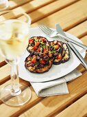 Grilled aubergines with olive salsa, glass of white wine