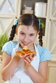 Girl eating a slice of pizza