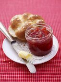 Strawberry and pineapple jam, butter and bread roll