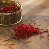 Saffron threads in and beside a small container