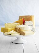 Various cheeses on cake stand
