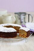 Apricot orange cake with icing sugar, a piece cut