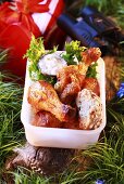 Chicken drumsticks with dip in plastic box for picnic