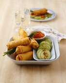 Meat-filled spring rolls with cucumber and spicy sauce