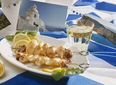 Squid kebabs, white wine and Greek table decoration
