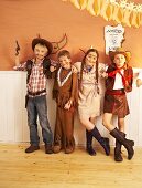 Four children dressed as cowboys and Indians