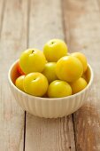 A bowl of yellow plums