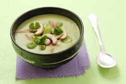 Creamy broad bean soup with ham and mushrooms