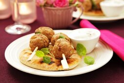 Turkey kofta with pita bread and a yogurt dip