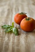 Two tomatoes and basil