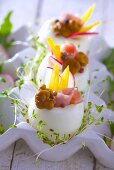 Boiled eggs stuffed with ham, mushrooms, peppers and cress