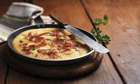 Apple and bacon pancake in a frying pan