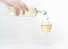 White wine being poured into a wine glass