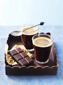 Two glasses of coffee and chocolate on tray