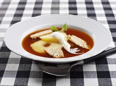 Warm rose hip soup with apple and whipped cream
