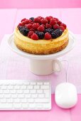 Cheesecake topped with raspberries & blackberries, computer